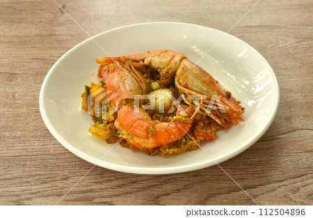 stir fried river shrimp in yellow curry and egg on plate 112504896