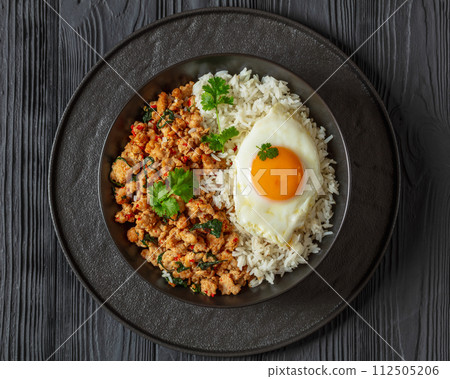basil chicken stir fry with rice and fried egg basil chicken stir fry with rice and fried egg 112505206