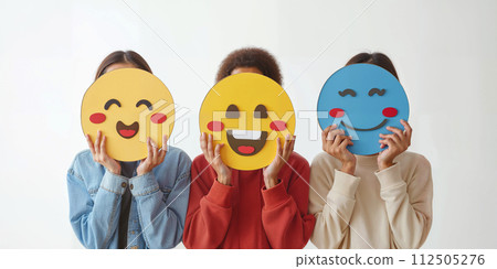 Healthy workplace culture concept. A group of diverse people holding happy emoticons. Teamwork 112505276