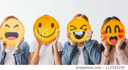 Healthy workplace culture concept. A group of diverse people holding happy emoticons. Teamwork 112505295