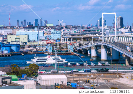 Japan's Yokohama cityscape overlooking Marine Rouge and Daikoku Dock. In the back is a group of tower apartments in front of Musashikosugi Station. Japan's Yokohama cityscape overlooking Marine Rouge and Daikoku Dock. In the back is a group of tower apartments in front of Musashikosugi Station. 112506111