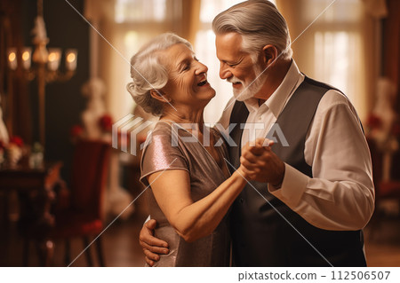 Joyful elderly couple dance closely at a festive celebration, exuding timeless romance 112506507