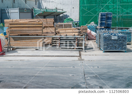 Construction site material storage area: Carrying in formwork materials Construction site material storage area: Carrying in formwork materials 112506803
