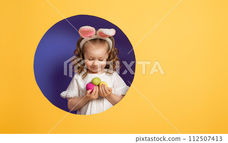 Girl with painted eggs 112507413