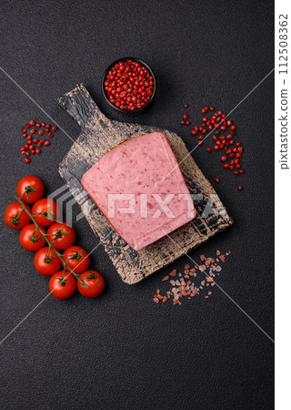 Delicious canned pink ham with salt, spices and herbs 112508362