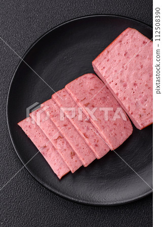 Delicious canned pink ham with salt, spices and herbs Delicious canned pink ham with salt, spices and herbs 112508390