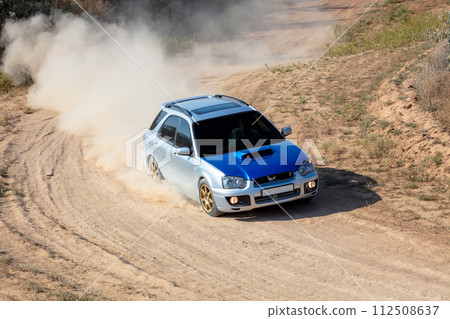 Rally Car in a Turn and a Cloud of Dust 23 Rally Car in a Turn and a Cloud of Dust 23 112508637
