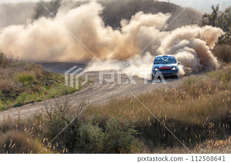 Rally Car in a Turn and a Cloud of Dust 26 Rally Car in a Turn and a Cloud of Dust 26 112508641