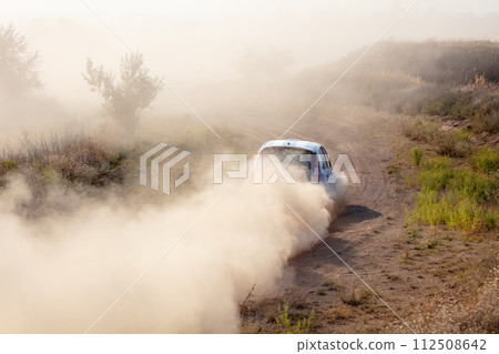 Rally Car in a Turn and a Cloud of Dust 27 Rally Car in a Turn and a Cloud of Dust 27 112508642