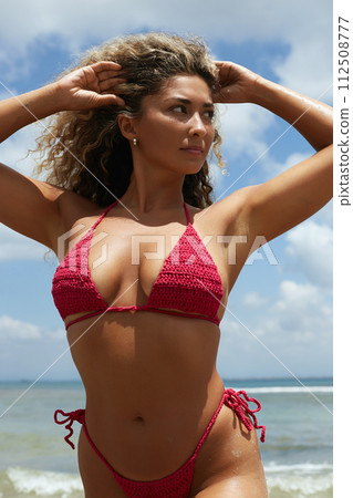 Beautiful woman on the beach. Sexy girl in Bikini near sea 112508777