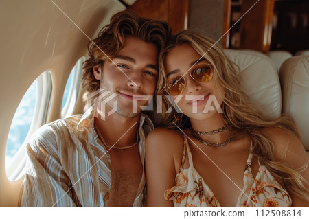 Young couple in an aircraft flying for holidays Young couple in an aircraft flying for holidays 112508814