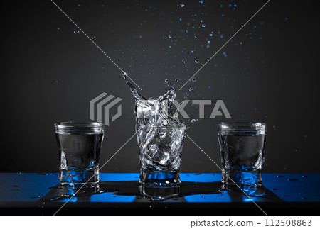 Alcoholic shots of vodka or strong drink in small glasses. Alcoholic shots of vodka or strong drink in small glasses. 112508863