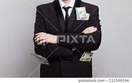 Dollar cash money and euro in businessman pocket closeup Dollar cash money and euro in businessman pocket closeup 112509194