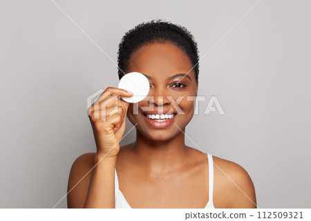 Cheerful healthy woman with fresh skin holding white cotton pad in her hand. Medicine 112509321