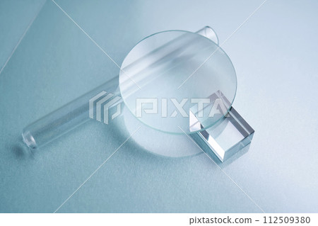 Glass objects and prisms on a blue background. 112509380