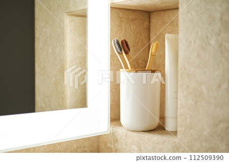 Natural bamboo toothbrushes in a glass in the bathroom. Natural bamboo toothbrushes in a glass in the bathroom. 112509390