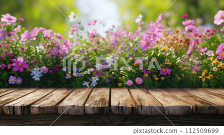 Spring summer soft background with flowers and wooden table for product presentation Spring summer soft background with flowers and wooden table for product presentation 112509699