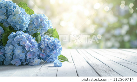 Spring summer soft background with flowers and wooden table for product presentation Spring summer soft background with flowers and wooden table for product presentation 112509714