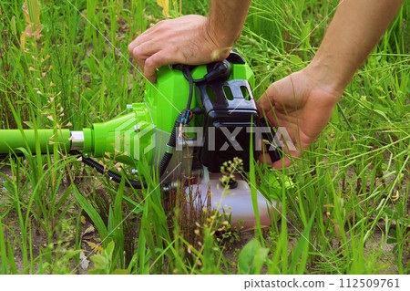 To start the grass mower. Servicing garden tools. 112509761