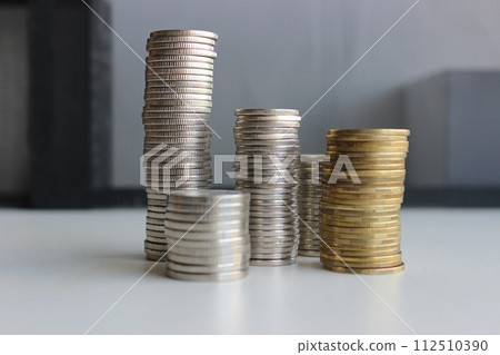 Different Coins In A Variety Piles On Black And White Background Different Coins In A Variety Piles On Black And White Background 112510390