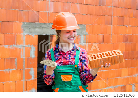 exploring tools. future engineer. happy kid use brick for renovation repairing. exploring tools. future engineer. happy kid use brick for renovation repairing. 112511366