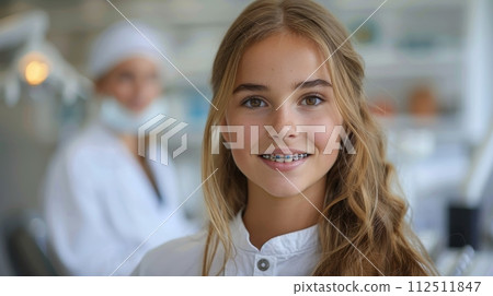 A young girl with braces is smiling at the camera 112511847