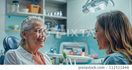 Dental Consultation: Orthodontist Discusses Procedure with Senior Patient Using Dental Model at Dentist's Office 112511848