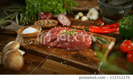 Raw Beef Steak Served on Wooden Cutting Board. 112512170