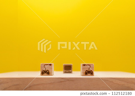 Yellow background with two game controllers lined up and connected to the TV to enjoy the game Yellow background with two game controllers lined up and connected to the TV to enjoy the game 112512180
