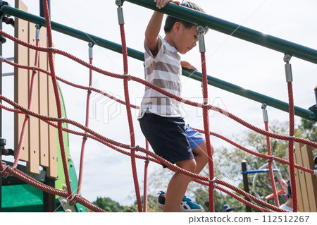 A boy playing around cheerfully A boy playing around cheerfully 112512267