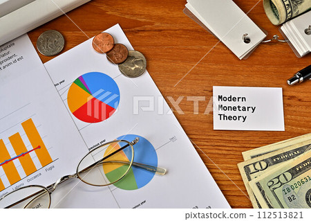 Desk with a card that says Modern Monetary Theory Desk with a card that says Modern Monetary Theory 112513821