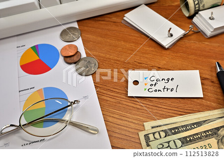 Desk with a card that says Change of Control 112513828