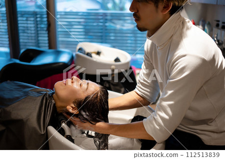Woman having shampoo at a beauty salon Woman having shampoo at a beauty salon 112513839