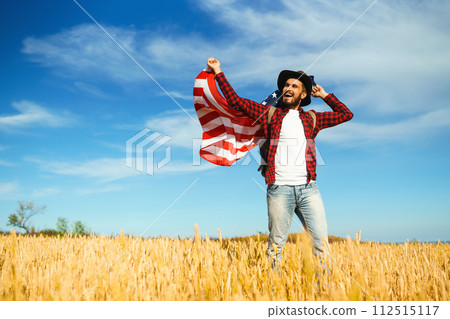 4th of July. American Flag.Patriotic holiday. Traveler with the flag of America. Beautiful sunset light. American style. 4th of July. American Flag.Patriotic holiday. Traveler with the flag of America. Beautiful sunset light. American style. 112515117