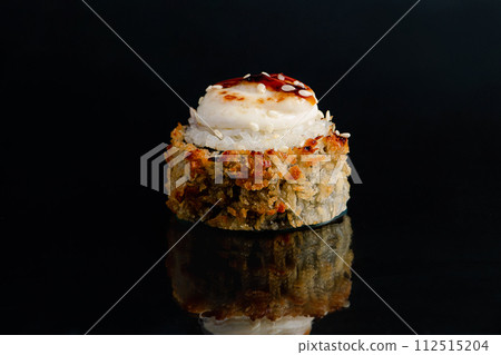 Tempura sushi roll on black background with reflection. 112515204