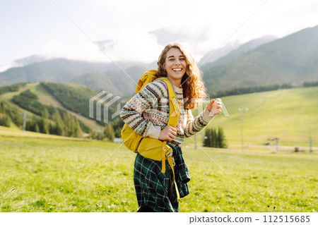 Young woman is having fun, walking through valley with stunning natural panorama. Adventure concept. Young woman is having fun, walking through valley with stunning natural panorama. Adventure concept. 112515685
