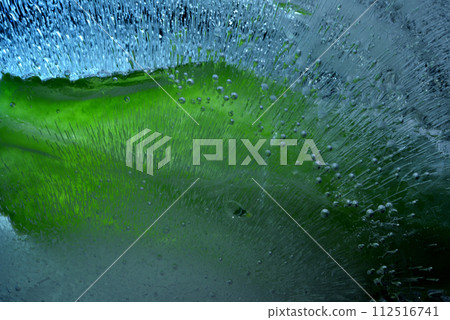 Close-up texture of ice cubes and green leaves Close-up texture of ice cubes and green leaves 112516741