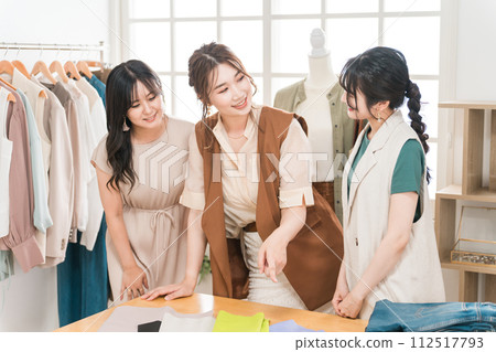 Women working in textile designers, fashion designers, pattern makers, stylists, and apparel. 112517793