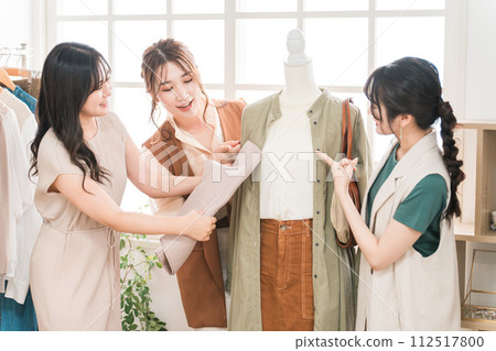 Women working in textile designers, fashion designers, pattern makers, stylists, and apparel. 112517800