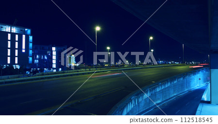 A city highway at night illuminated by streetlights A city highway at night illuminated by streetlights 112518545