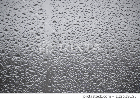 Close-up view of a window covered with raindrops 112519153