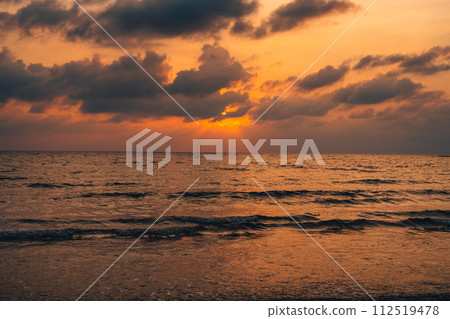 Sunset at sea with orange sky and waves 112519478