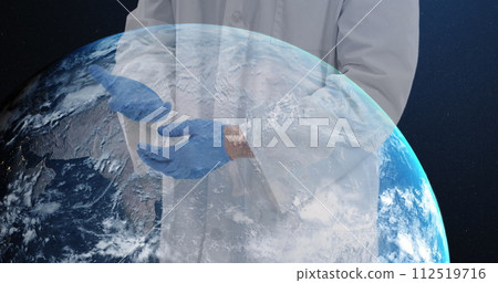 Mid section of male doctor wearing surgical gloves against globe spinning on blue background 112519716