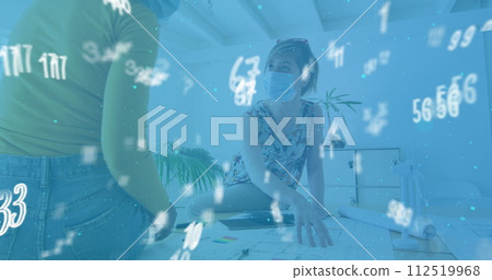 Image of floating numbers with colleagues in office wearing face masks Image of floating numbers with colleagues in office wearing face masks 112519968