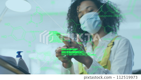 Image of digital interface showing statistics with woman in office wearing face masks 112519973