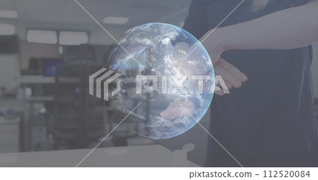 Image of globe spinning with woman disinfecting hands in office Image of globe spinning with woman disinfecting hands in office 112520084