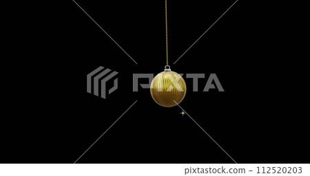 Gold christmas bauble swinging with gold stars on black background 112520203