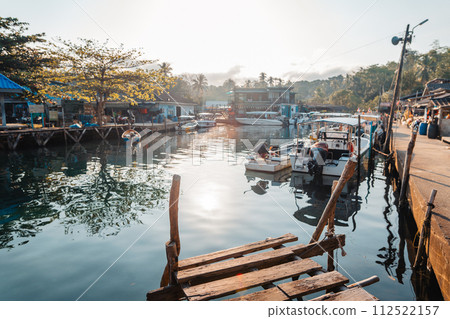 Boat at rural pier on island in the morning Boat at rural pier on island in the morning 112522157