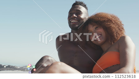African American couple enjoys a sunny beach day, with copy space 112523618
