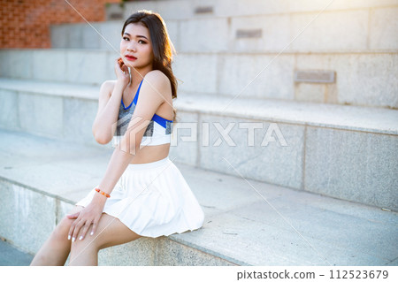 Portrait of beautiful athletic young asian woman in fashionable sportswear standing and having rest after strong exercise training in garden the park,Outdoor Sporty concept Portrait of beautiful athletic young asian woman in fashionable sportswear standing and having rest after strong exercise training in garden the park,Outdoor Sporty concept 112523679